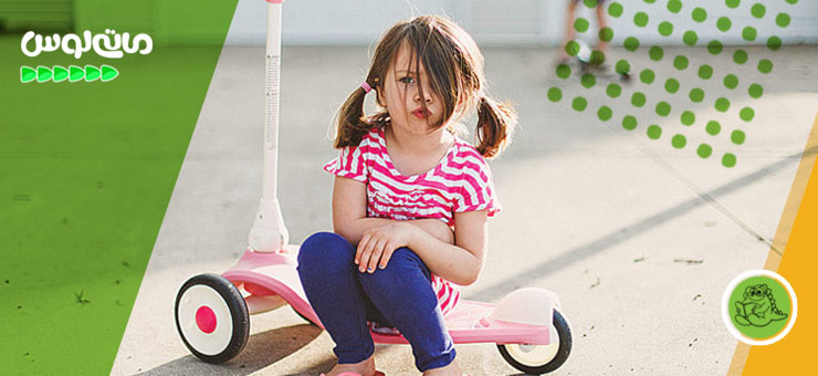 دختربچه ناراحت روی اسکوتر خود نشسته است